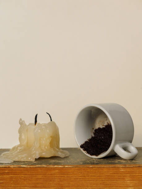 istock An extinguished candle and a Cup with the remnants of coffee for divination on coffee grounds 1200132522