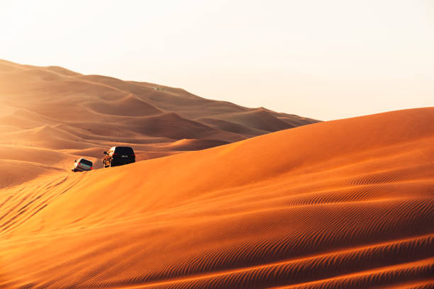 Desert sand dunes and safari experience at sunset stock photo