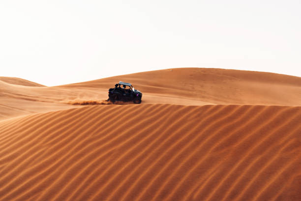 istock Off road car dune bashing in Arabian desert 1200134706
