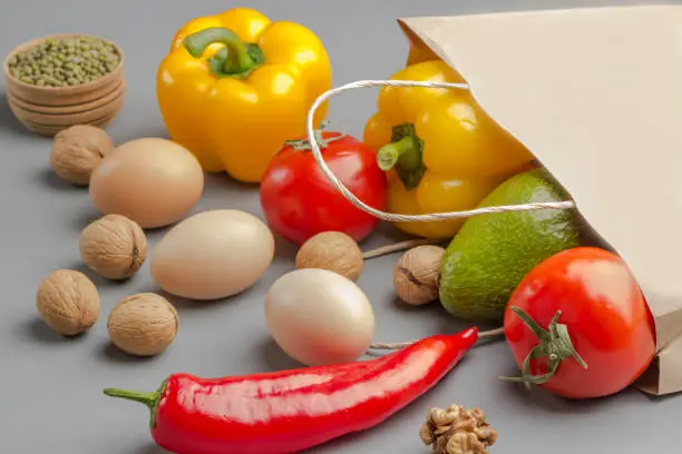 Photo of A set of products for healthy eating. Paper bag with walnuts,