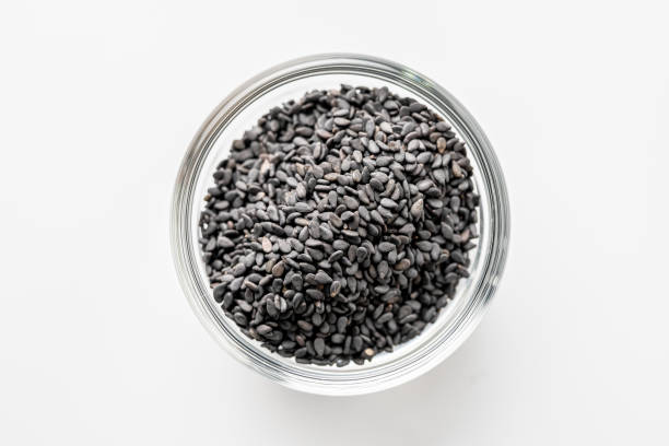 istock Black sesame seeds in a cup on a white background. 1200139544