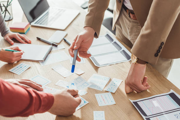 istock Cropped view of designers developing user experience design with sketches on table 1200140337