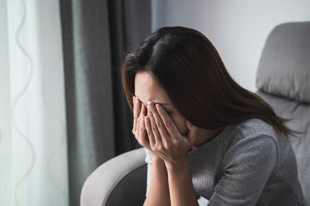 istock Depressed and sadness woman crying alone at home 1200142136