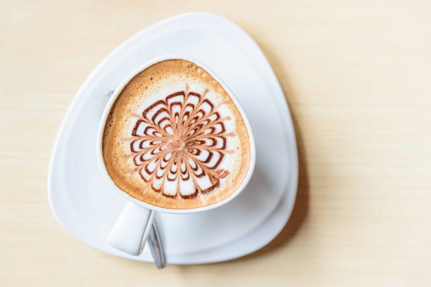 istock Top view of hot coffee on table / hot cappuccino with nice pattern milk foam 1200143581