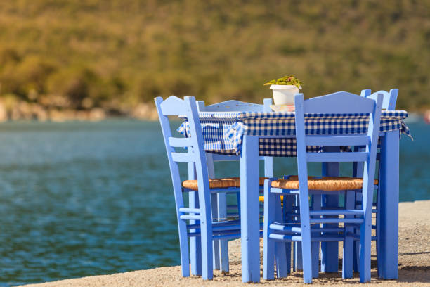 istock Open cafe outdoor restaurant in Greece on sea shore 1200143811
