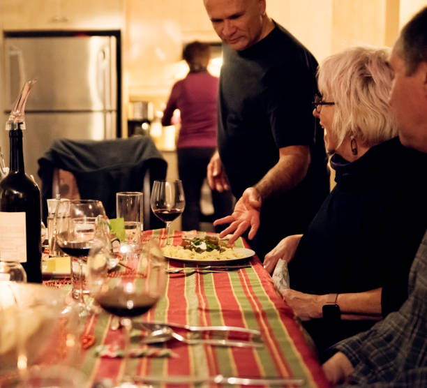 istock Family members enjoying a meal together. 1200145530