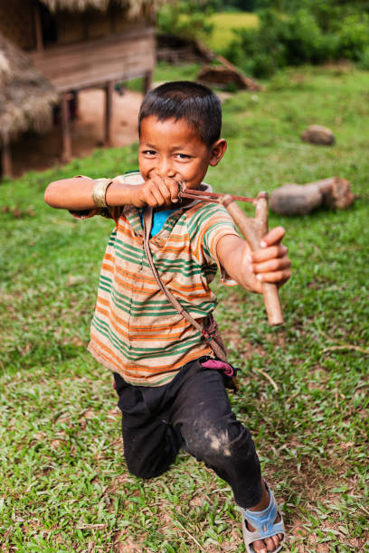 istock Young boy with slinghshoot in Northern Laos 1200145854