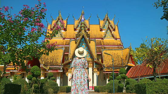 Female traveler being impressed by the gorgeous Wat Wang Wiwekaram temple in Sangkhlaburi, Thailand, (Self Portrait)