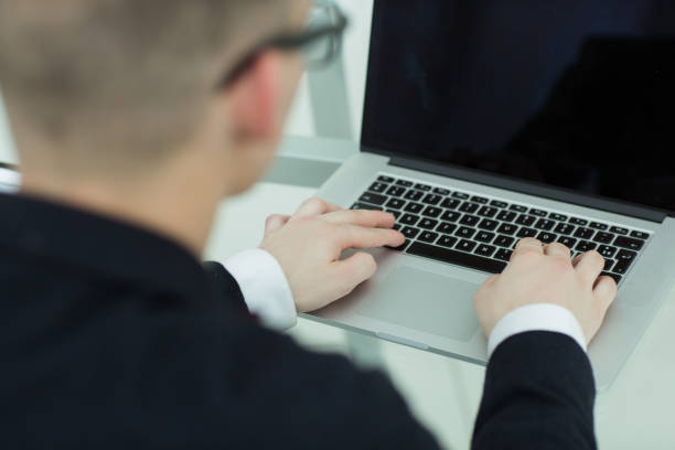 istock close up. young businessman typing on laptop. 1200148869