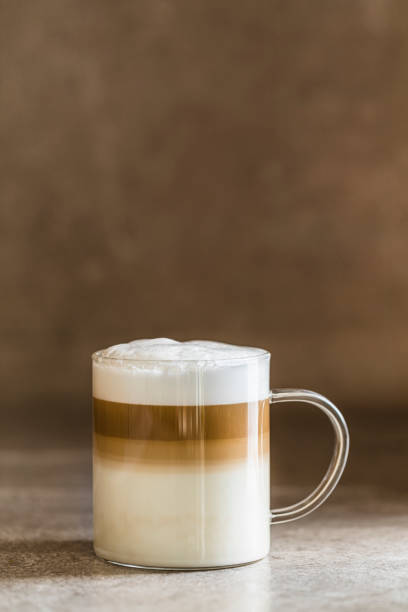 a glass of caffe latte macchiato coffee - cafe macchiato latté heat coffee imagens e fotografias de stock