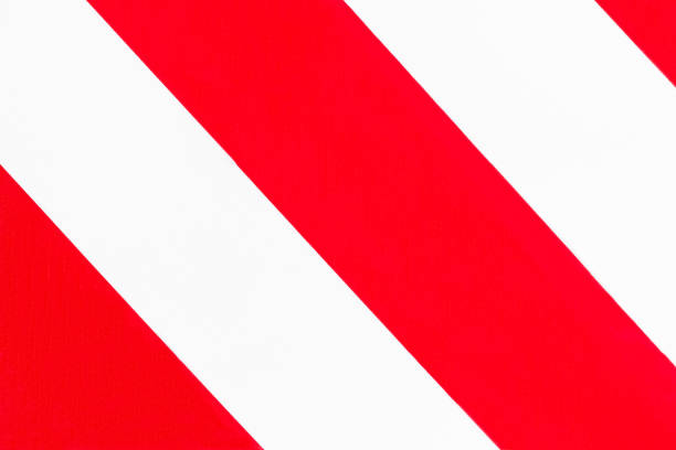 istock Striped background of red and white diagonal stripes. 1200150068