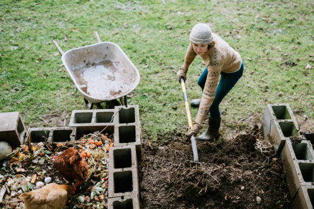 istock Woman Scooping Nutrient Rich Compost into Wheelbarrow 1200151535