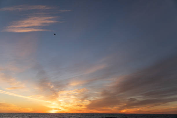 A colorful sunset with clouds over the ocean