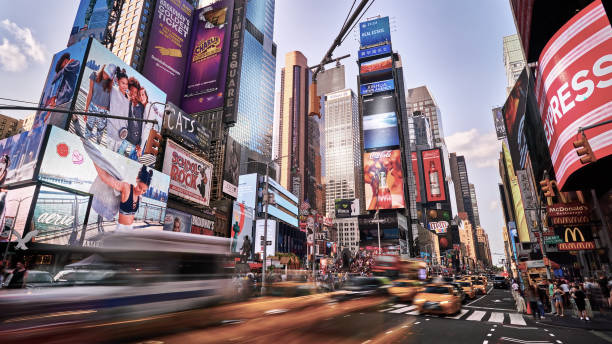 motion at times square. traffic. yellow taxi. day. - new york city times square crowd people imagens e fotografias de stock