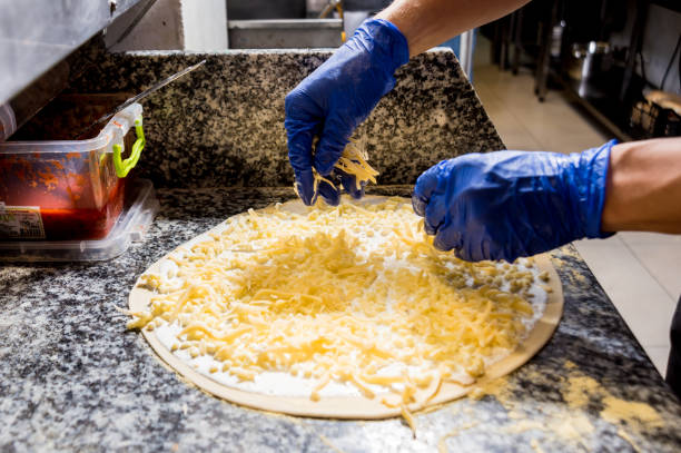 istock The process of making pizza. Hands of chef baker making pizza at cafe kitchen 1200154063