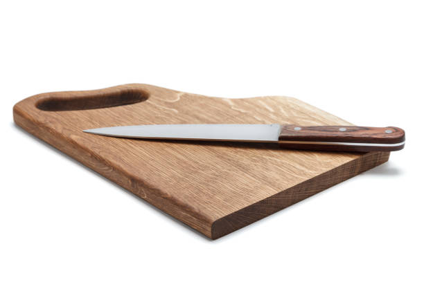 kitchen knife lying on a cutting board, white background - putty knife imagens e fotografias de stock