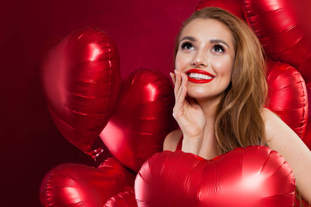 Young pretty woman holding red balloons. Birthday, Valentine's day, celebration and holiday background Young pretty woman holding red balloons. Birthday, Valentine's day, celebration and holiday background valentine s day holiday stock pictures, royalty-free photos & images