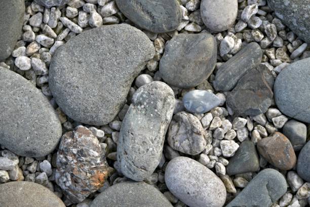 istock A stone horizontal background of sea pebbles and light rubble. 1200156815