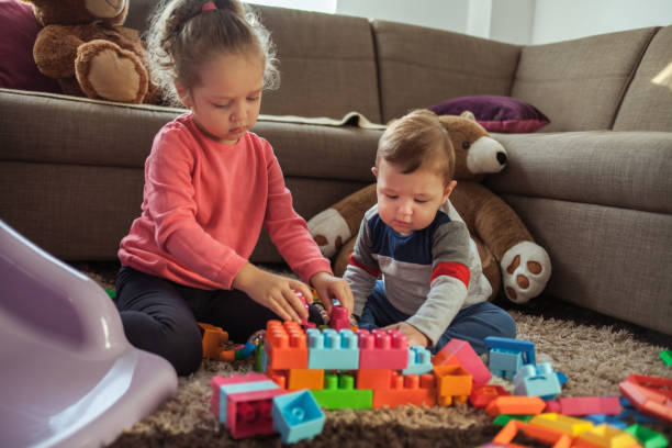 istock Babies playing with toys at home 1200159774