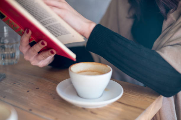 woman with a book and cup of hot drink