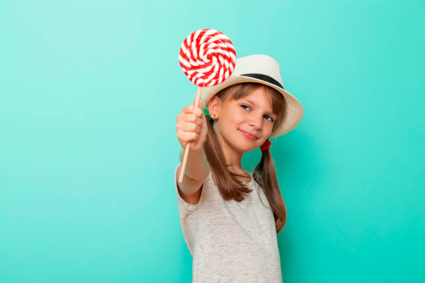 istock Little girl holding lollipop 1200163417