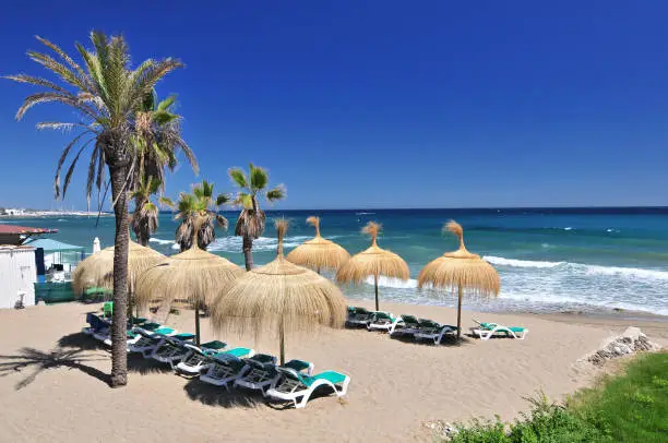 Photo of Beach in the popular resort of Marbella in Spain, Costa del Sol, Andalucia region, Malaga province.