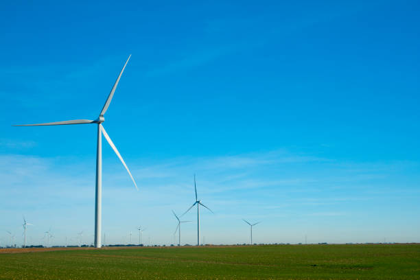 istock Wind turbines on a plain of green farm fields 1200166530