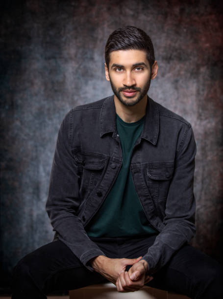 Attractive Indian male with fair skin wearing cool denim jacket stock photo