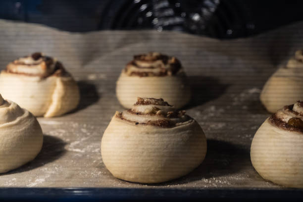 istock Rolls with cinnamon, nuts and raisins are baked in the oven 1200171137