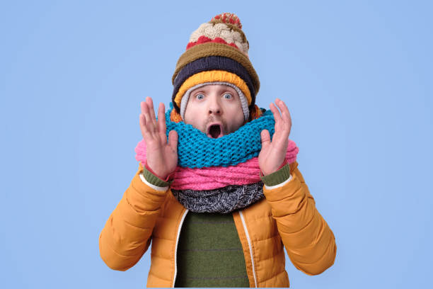 istock Handsome caucasian funny man in several hats and scarfs. 1200171262