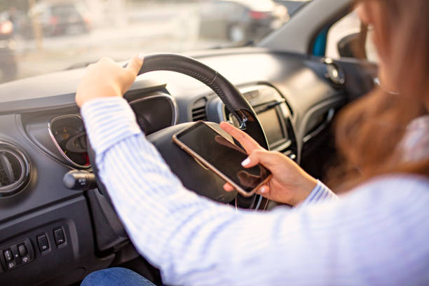 istock Woman texting message using cellphone sitting in car. 1200171943