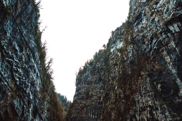 Stone bag Abkhazia in spring. Canyon road surrounded by rocks.Trees grow on a ridge. Cliffy mountains above the road. Unusual place in mountainous areas.