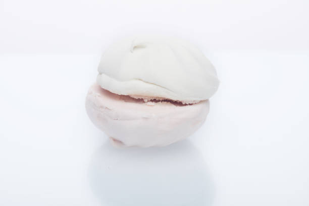 istock White-pink marshmallow with strawberry flavor on a white plate with reflection 1200181696