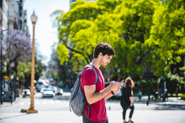 istock Young Male Backpacking Vacationer Checking Smart Phone 1200182797