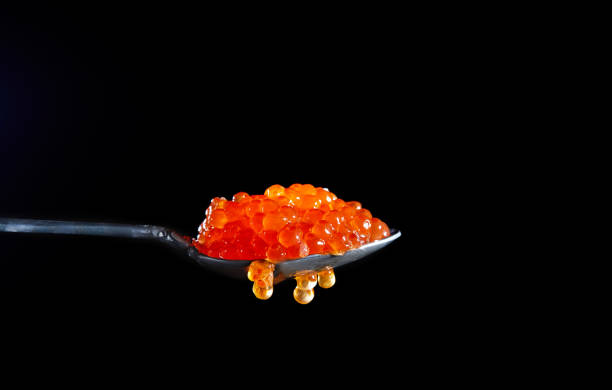 istock A spoon full of red caviar on a black background 1200182890