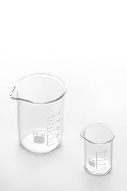 istock Two glass beakers on a white background 1200188434