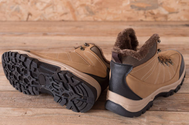 istock Leather sneakers with fur on wood background 1200191574