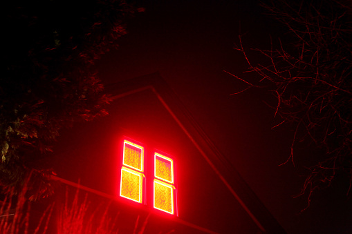 Red neon light in a window in Portland, Oregon.