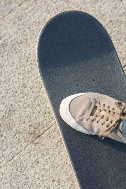 istock Skateboarder riding skateboard at city 1200196210