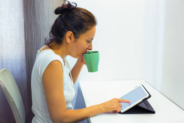 istock Morning reading news on digital tablet 1200198802