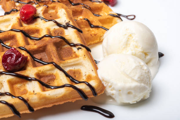 istock Viennese waffles with ice cream, chocolate and cherry. Close-up. 1200200894