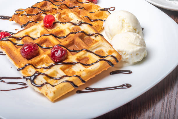 istock Viennese waffles with ice cream, chocolate and cherry. 1200200911