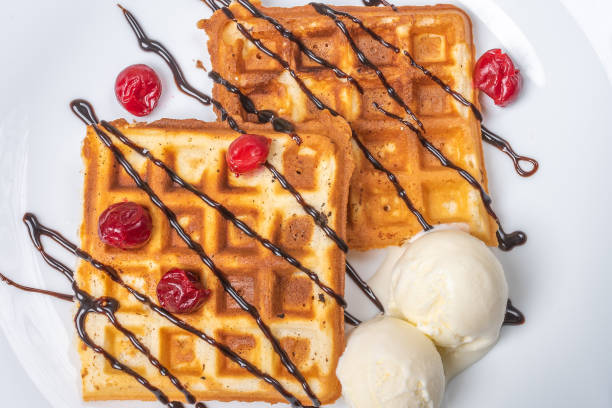 istock Viennese waffles with ice cream, chocolate and cherry. Close-up. Background 1200200951