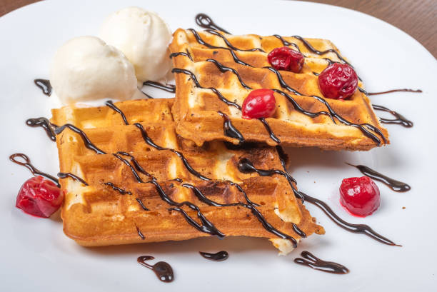 istock Viennese waffles with ice cream, chocolate and cherry. Close-up. On the plate 1200201037