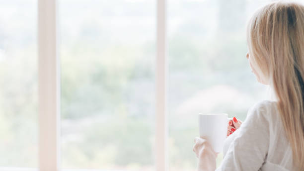 morning coffee pensive woman window mug hot drink - wakening imagens e fotografias de stock