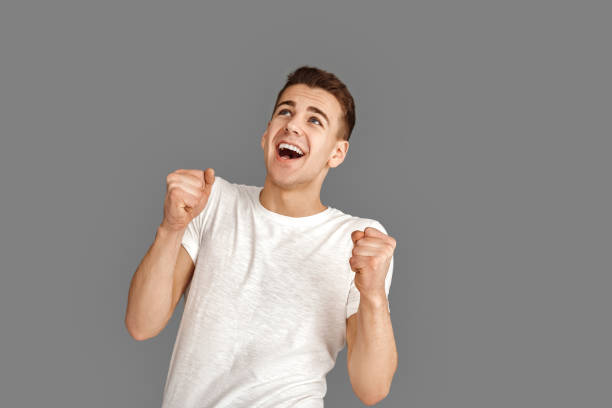 istock Copy Space for Text or Product. Young man standing isolated on grey looking up surprised 1200206169
