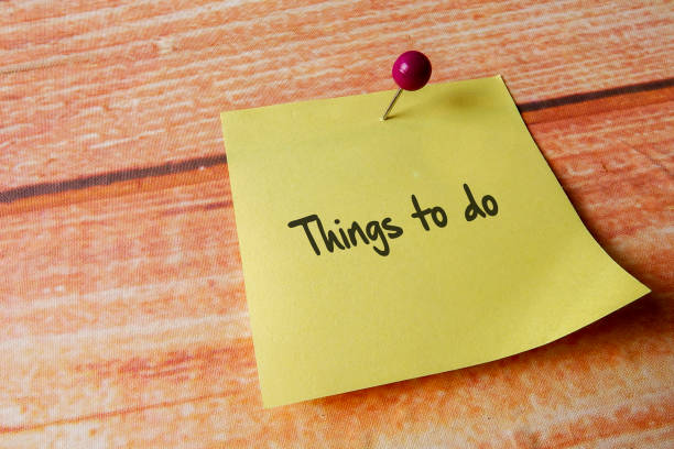 istock Yellow pinned note over wooden background with common message 1200207233