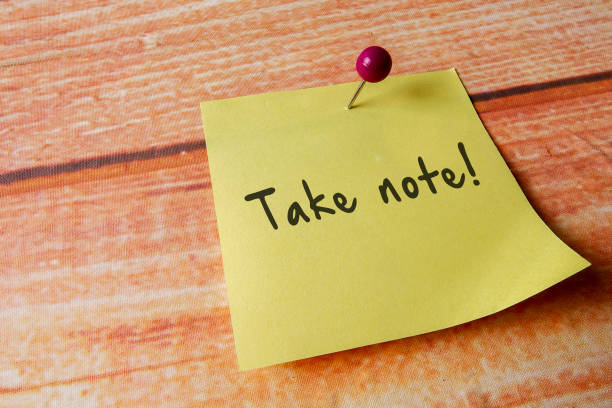 istock Yellow pinned note over wooden background with common message 1200207250