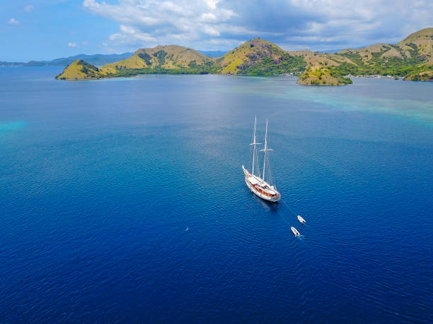 Beautiful aerial view of beaches and tourist boat sailing in Flores Island, Indonesia Beautiful aerial view of beaches and tourist boat sailing in Flores Island, Indonesia pulau komodo stock pictures, royalty-free photos & images