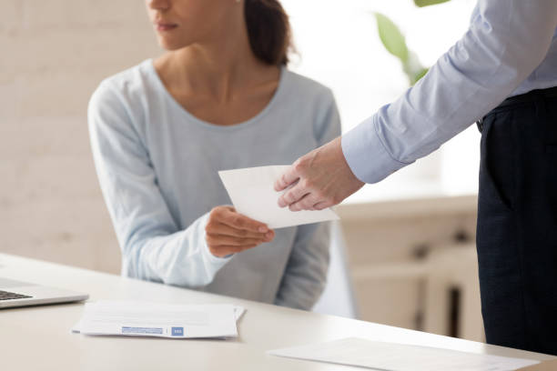 istock Cropped image young company employee getting salary in envelope. 1200214107
